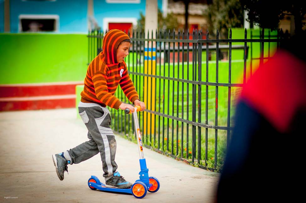 A boy riding his brand new scooter!