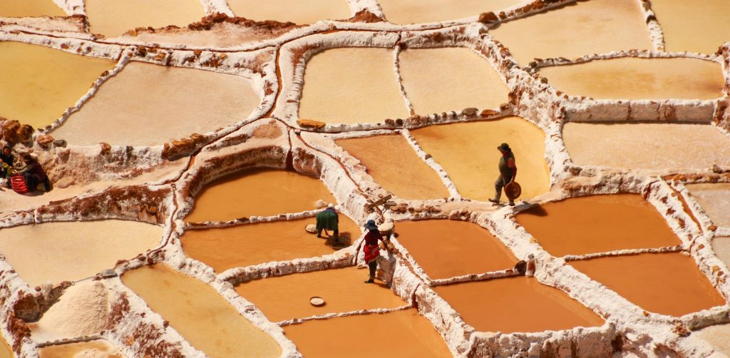 People harvesting salt from Maras ponds